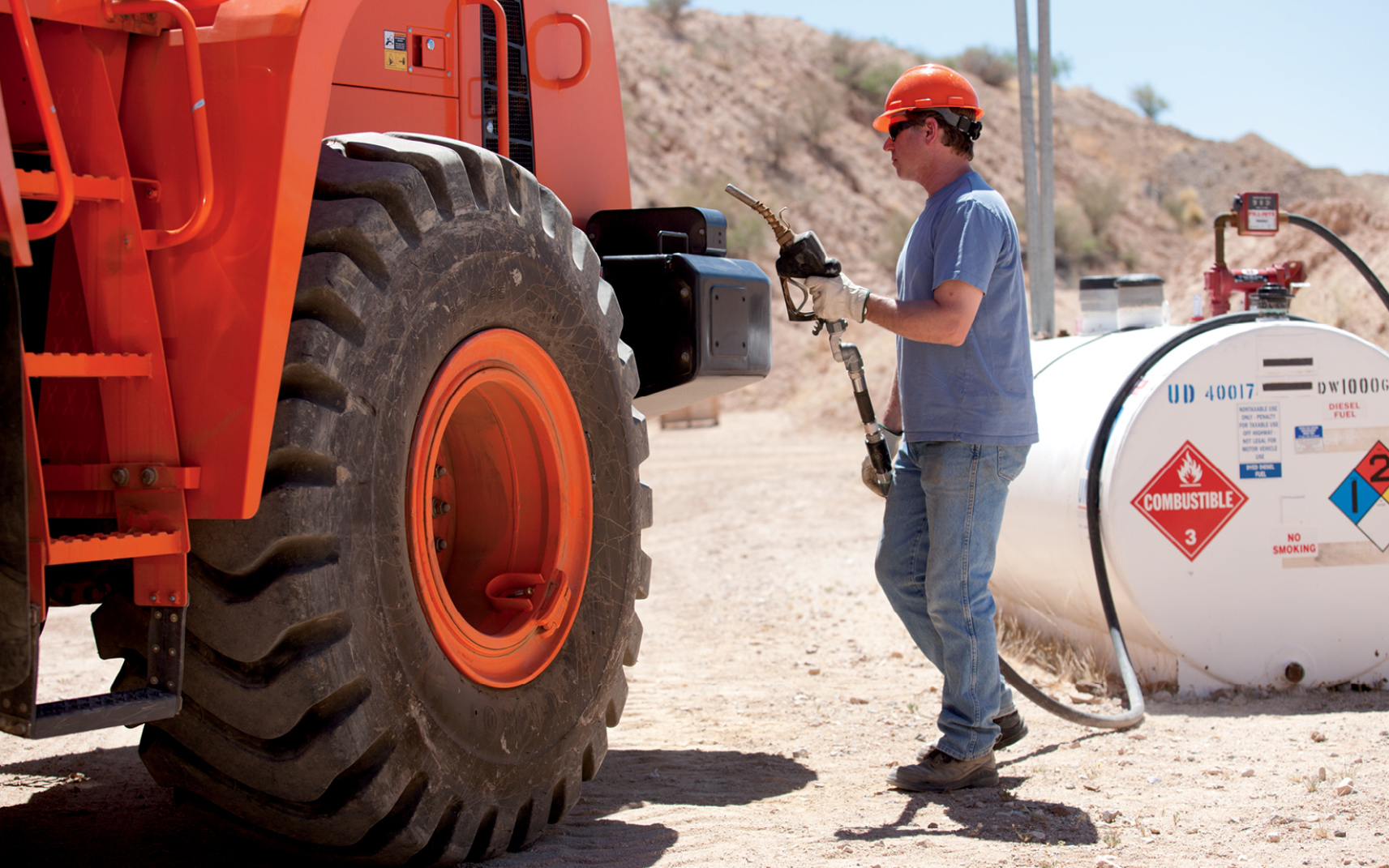 An operator adds diesel fuel to a DEVELON wheel loader.