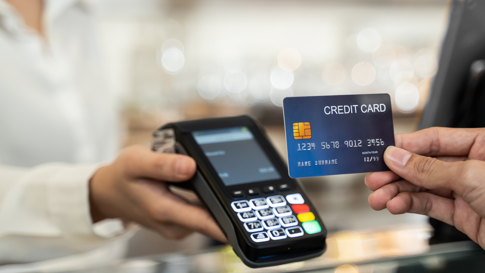 Close up shot of customer hand using dummy credit card for payment to waitress at cashier in cafe restaurant, money cashless and credit card payment technology concept.