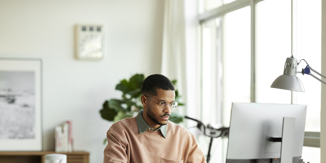 Freelancer Using Computer At Home Office