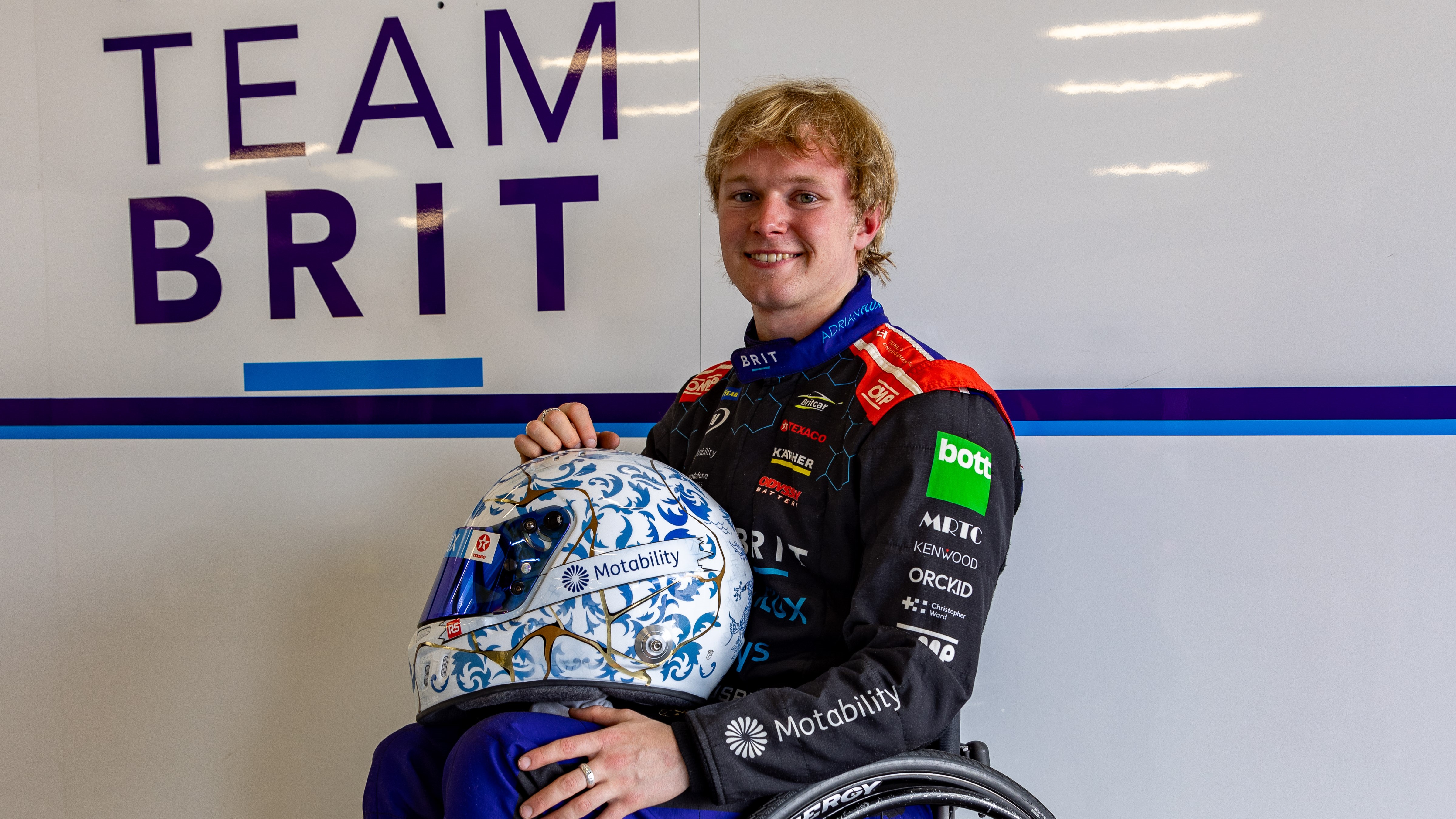Noah holding his custom-designed helmet