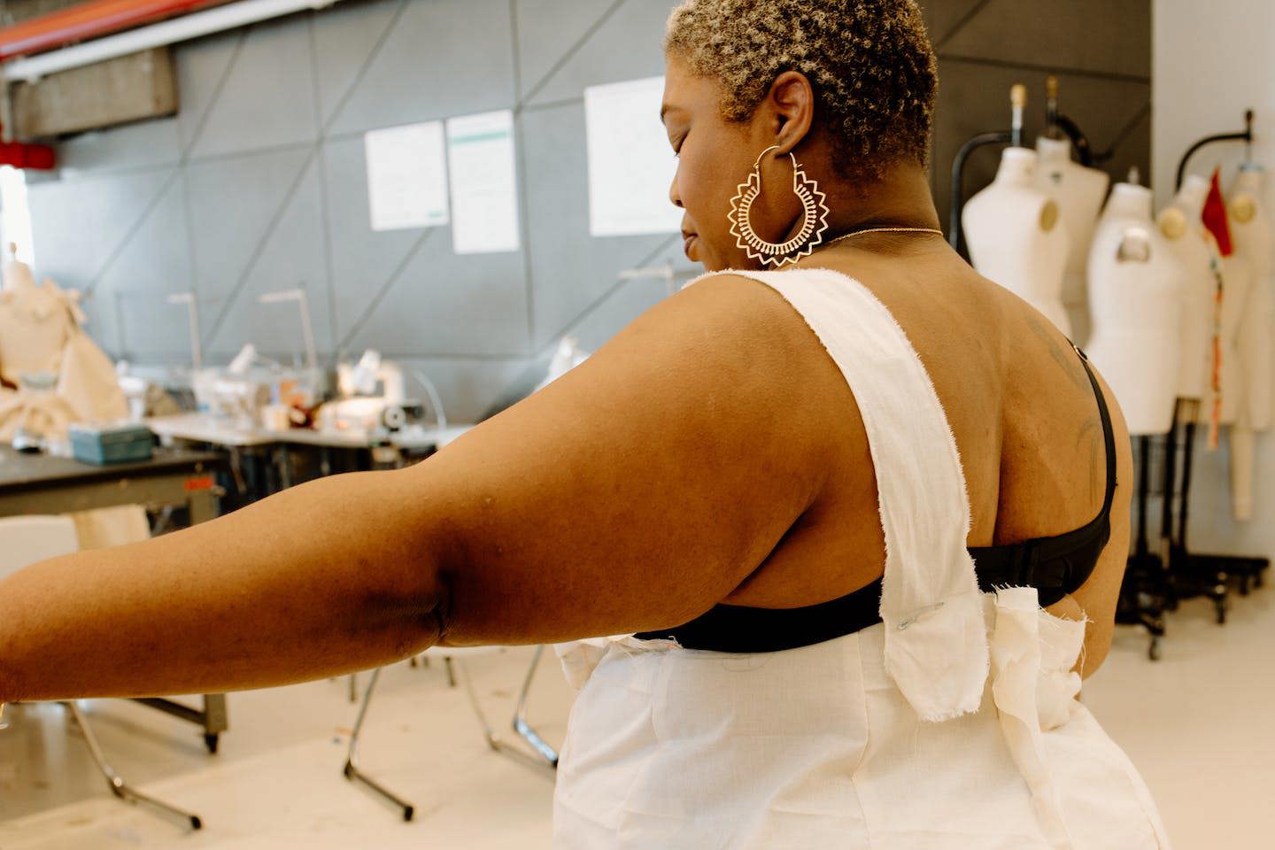 Model trying on garment in development.