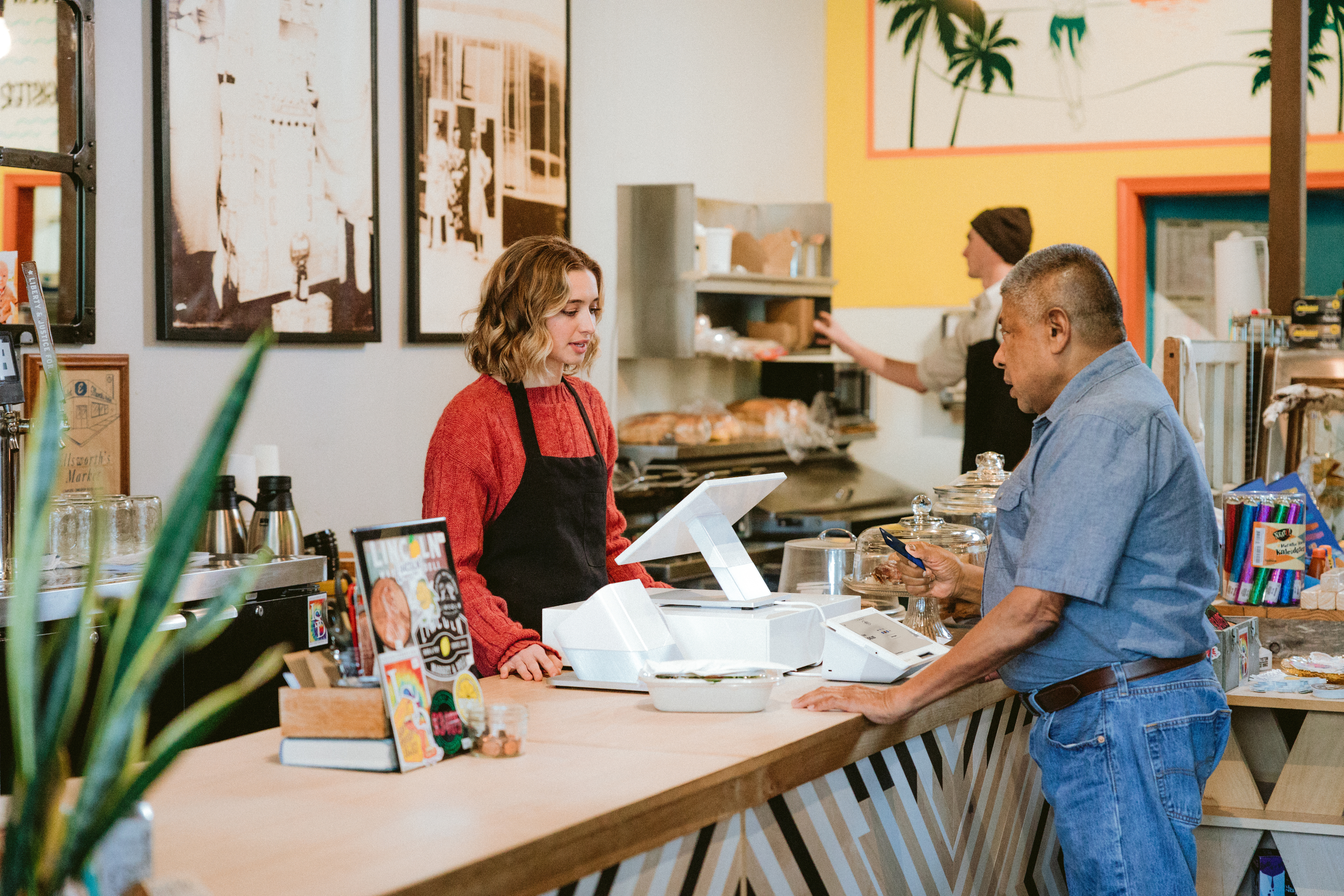 customer presenting card at counter to pay using terminal