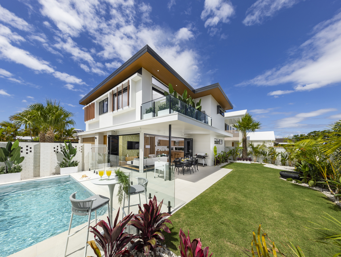 Backyard photo of the house showcasing an outdoor dining room, living room, pool area and a Balcony