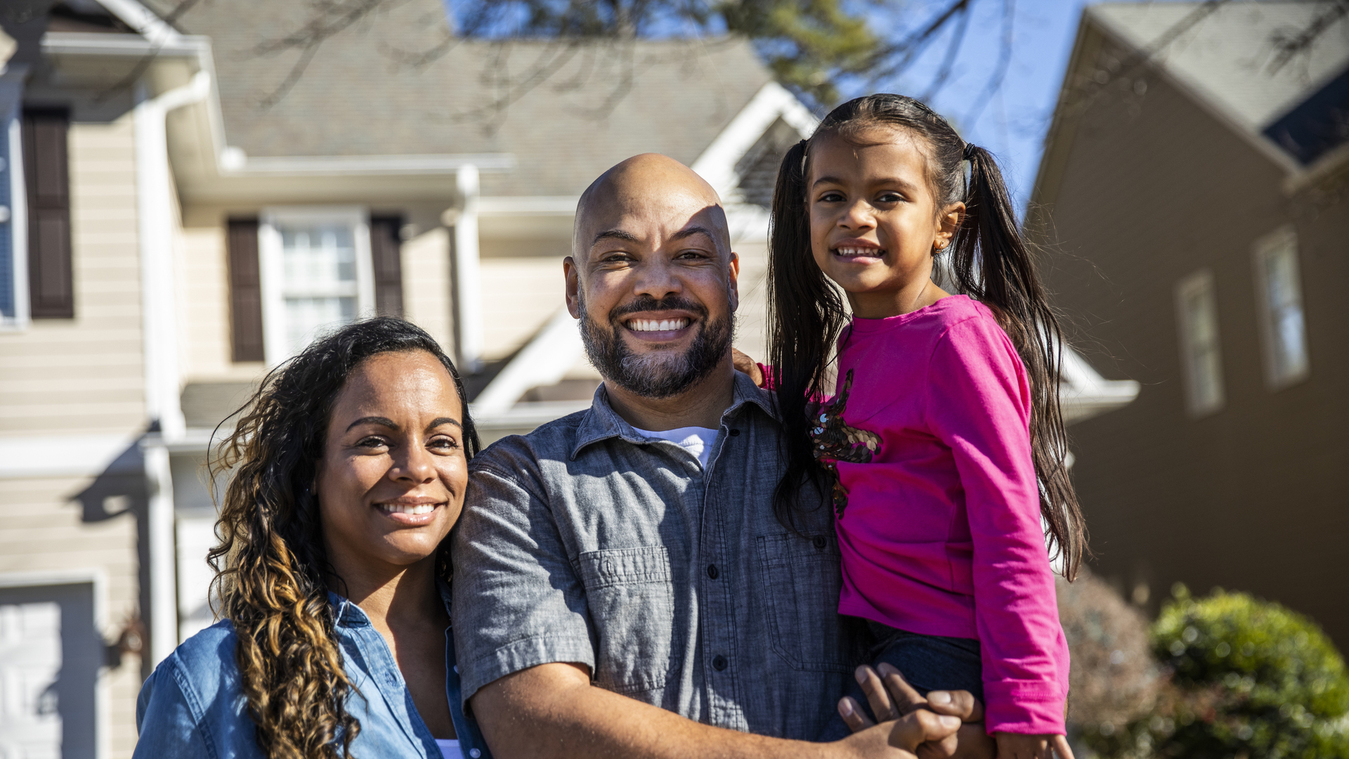 Portrait of family in front of home