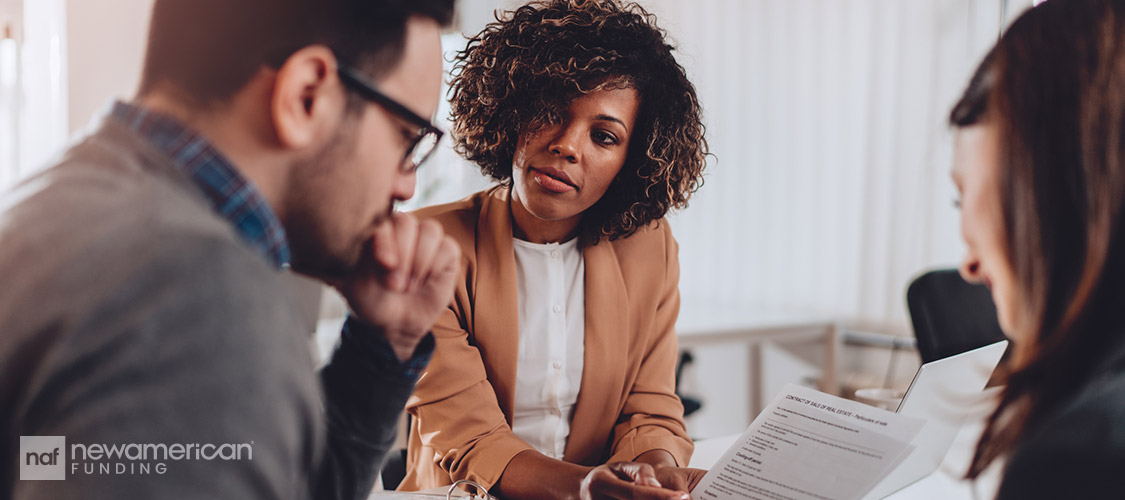 agent going over paperwork with clients