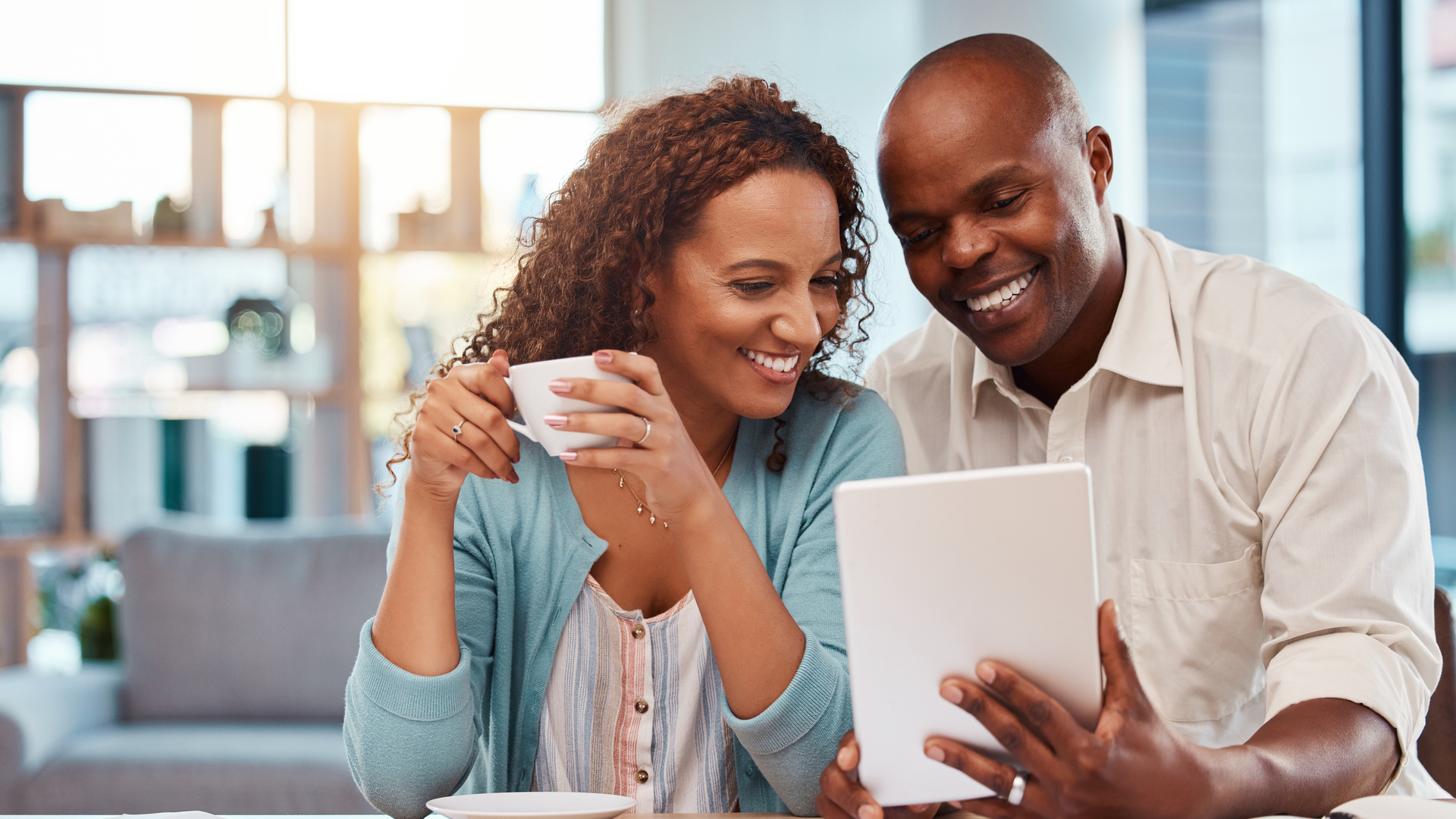 Couple, tablet and planning for finance, budget or application for loan on fintech app in home. Happy black man, woman or reading on touchscreen ux with smile, financial goals and investment growth