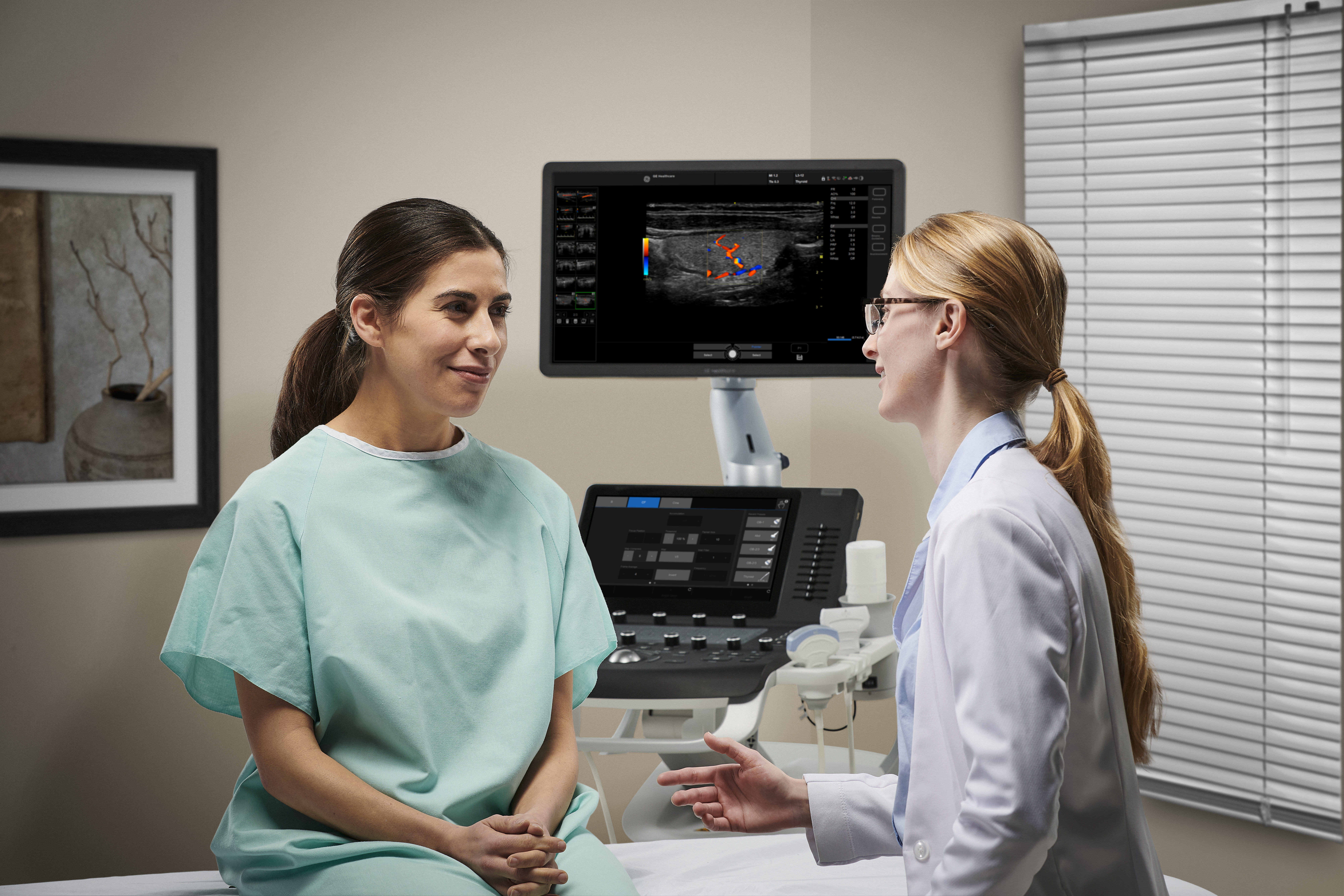 A clinician speaks to a patient before an ultrasound exam.