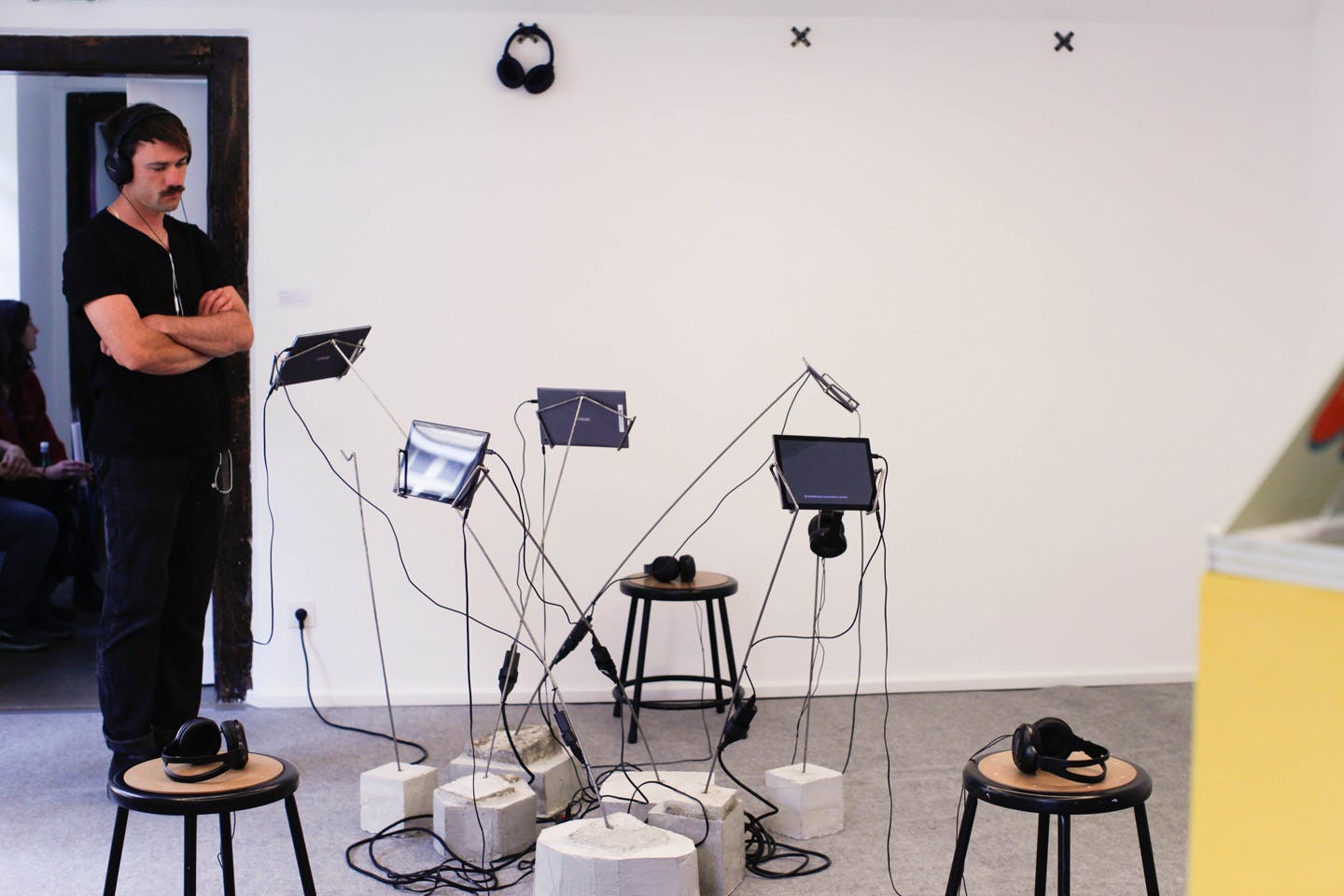 Interactive sound installation with tablets, headphones, and stools