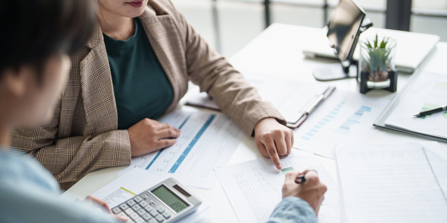 business man Auditor or internal revenue service staff checking annual financial statements company Audit Â Accounting tax.