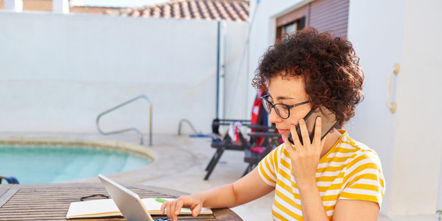 Young business woman telecommuting at an outdoor site