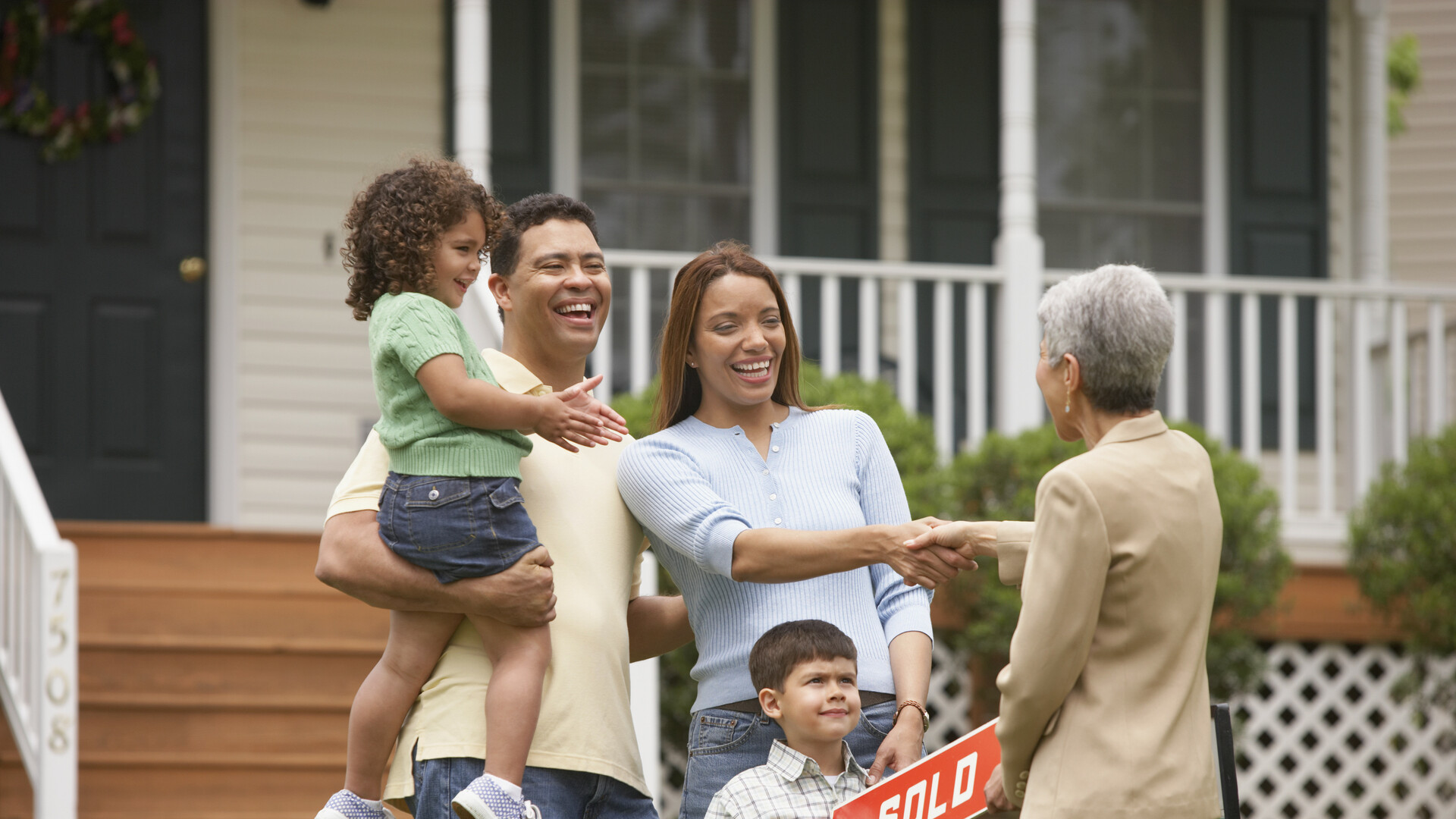 Family shaking hands with Real Estate Agent