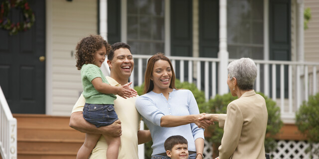 Family shaking hands with Real Estate Agent