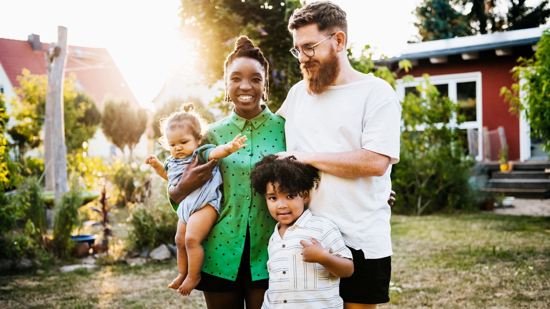 Portrait Of Mixed Race Couple Outdoors With Children