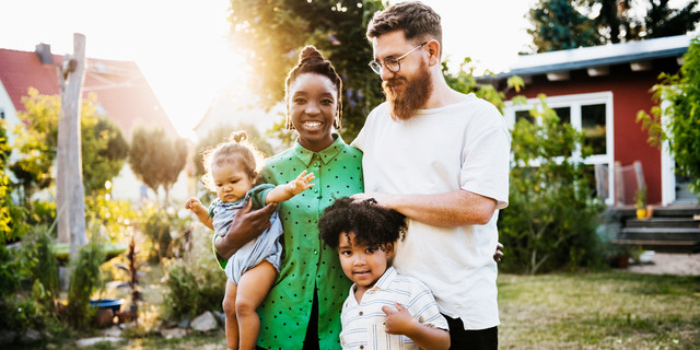 Portrait Of Mixed Race Couple Outdoors With Children