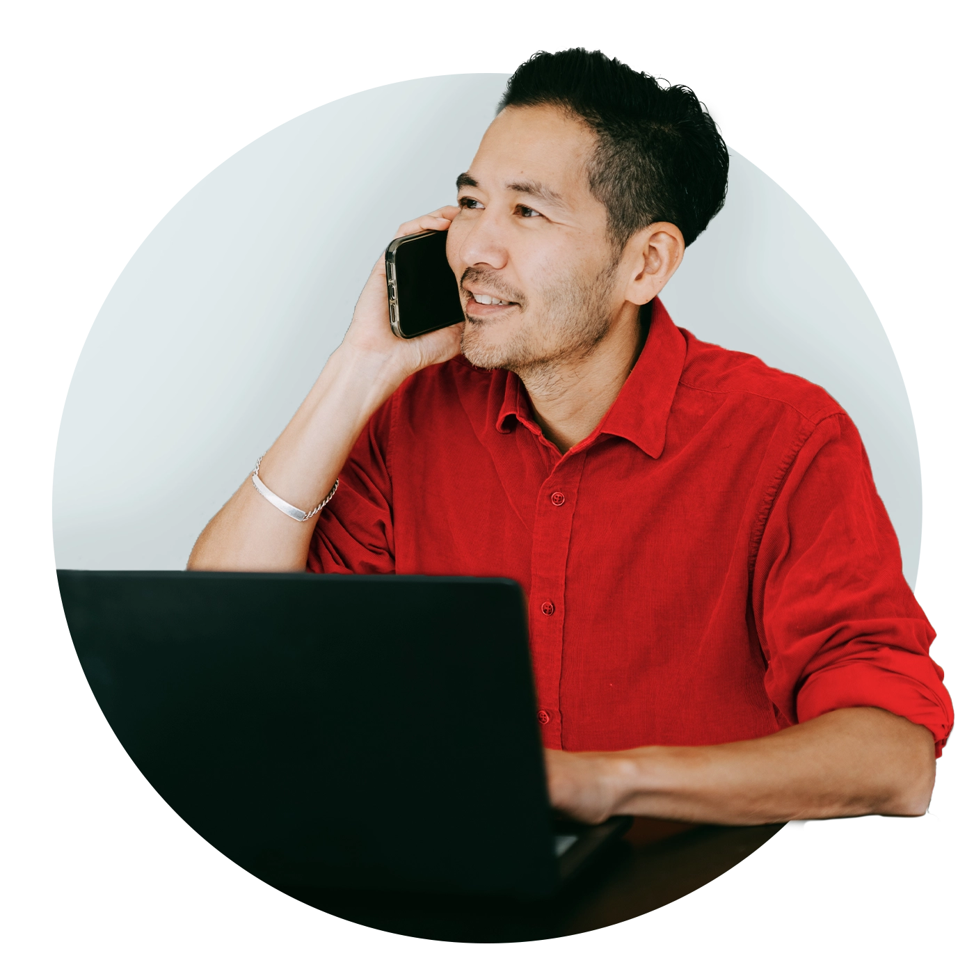 man-with-red-shirt-on-the-phone-with-laptop-open 1400px.webp