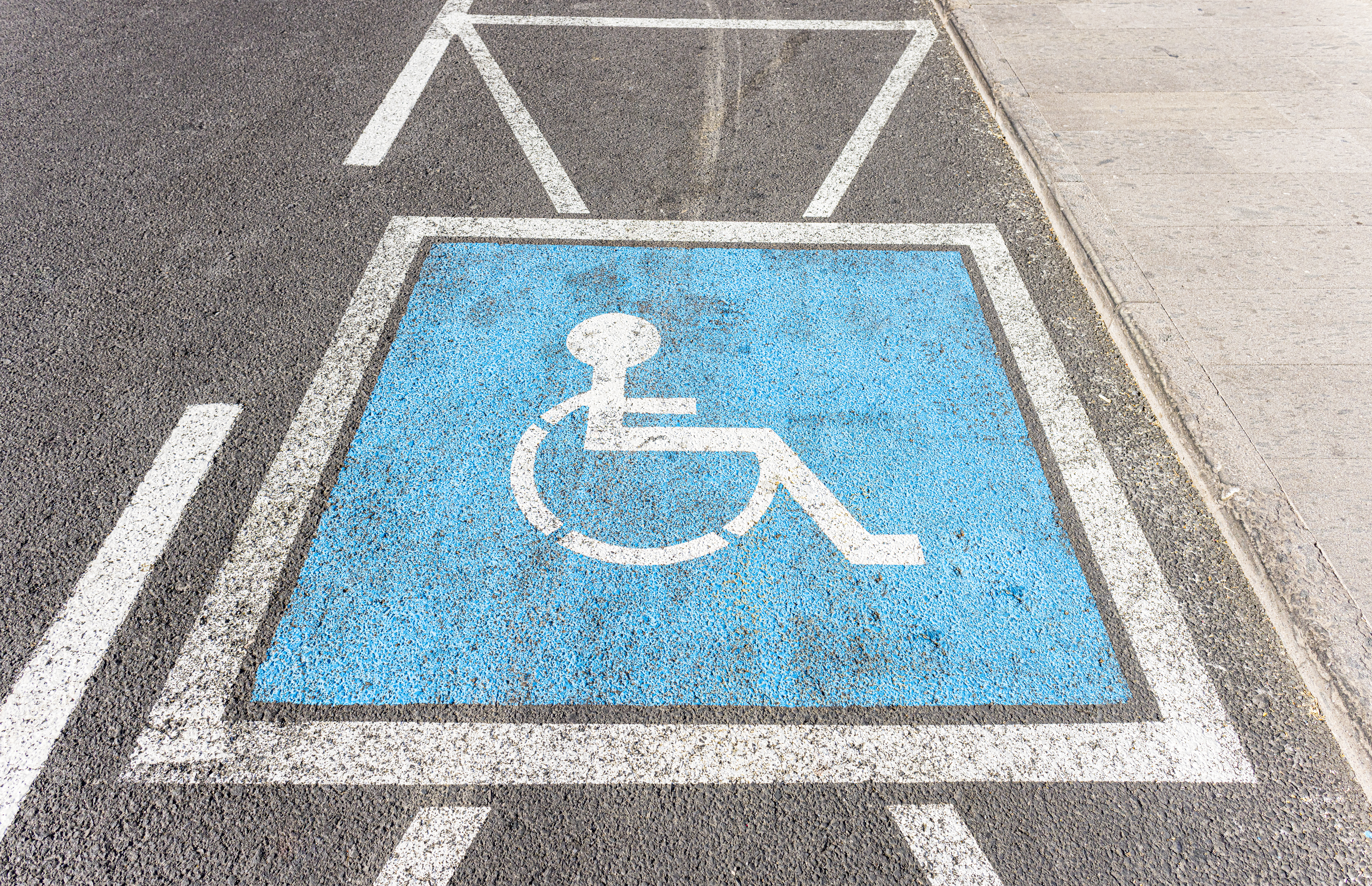 Disabled car parking spot showing an image of a wheelchair