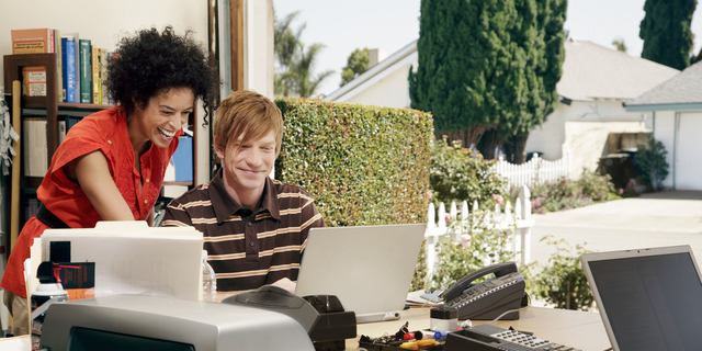 Man and woman working at desk in garage