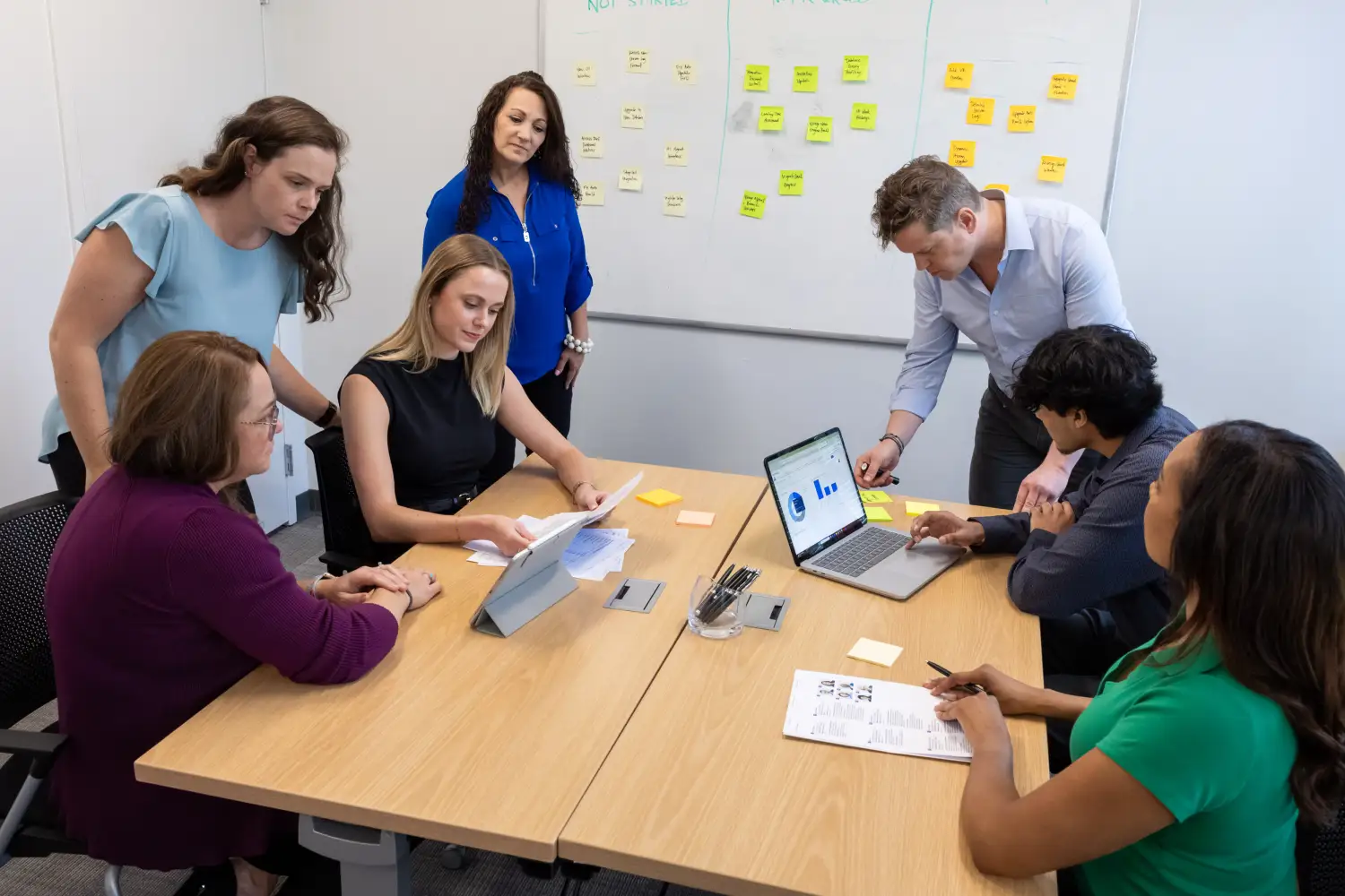 Services professionals using Certinia PS Cloud to analyze real-time data and brainstorm billing automation solutions.