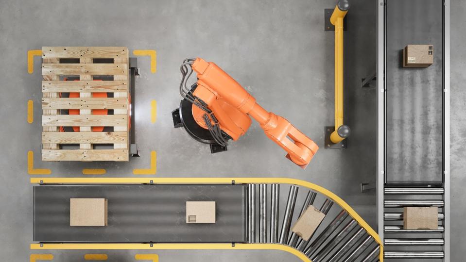 Industrial robots working on a conveyor belt in a smart warehouse