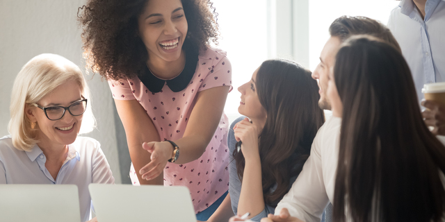 International company diverse members working together laughing having fun