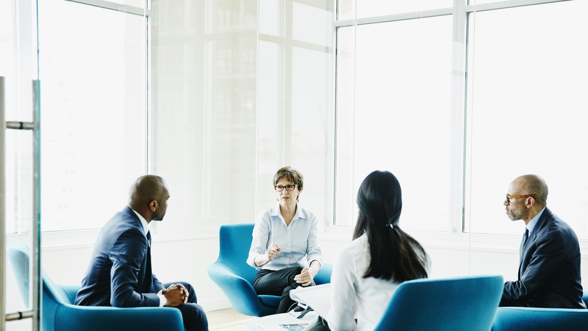 Mature businesswoman leading meeting in office