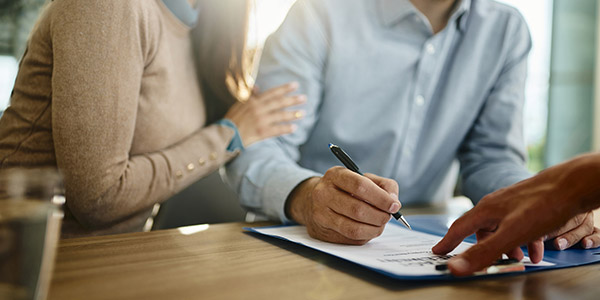 couple signing paperwork