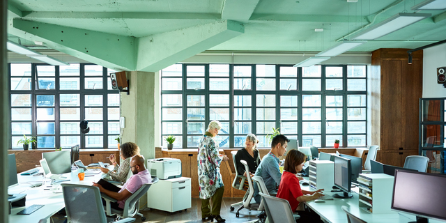 Large light and airy modern open plan office with staff