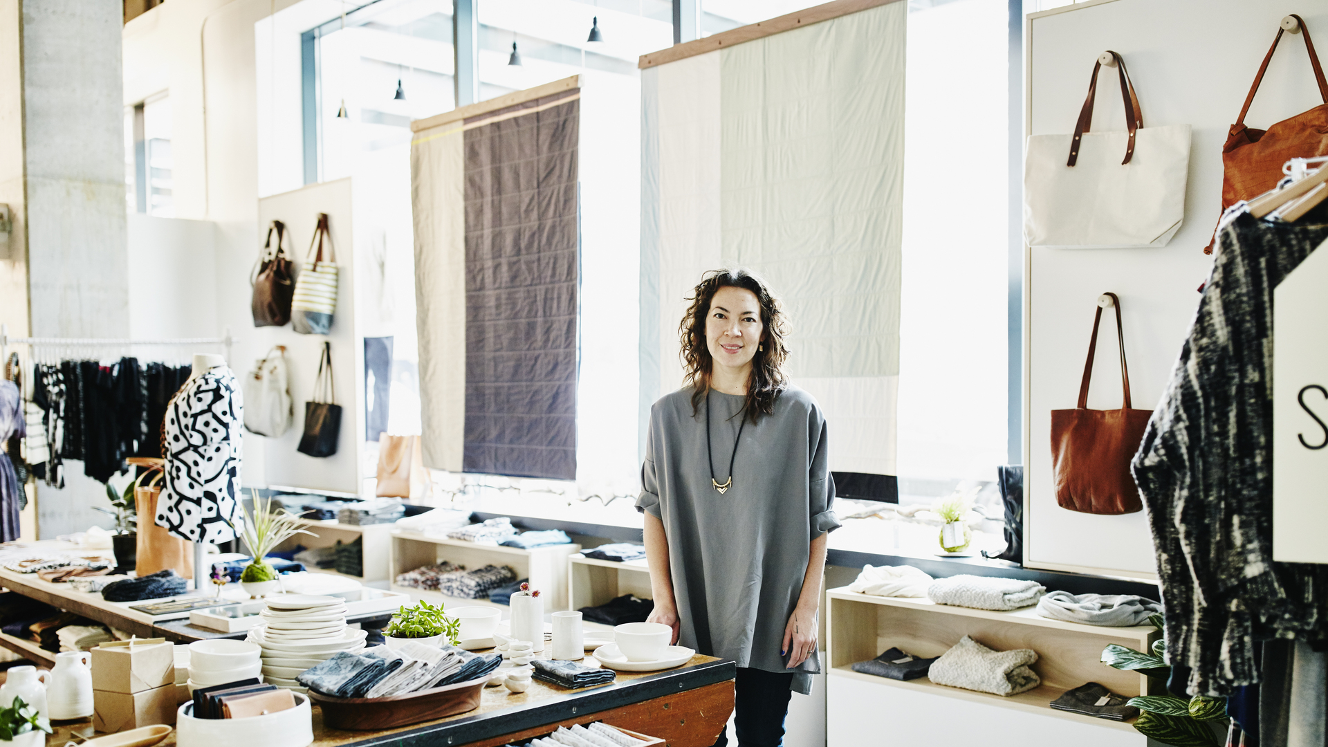 Smiling female business owner in boutique shop