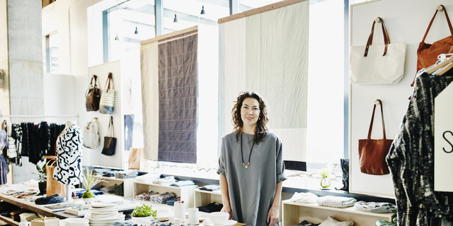 Smiling female business owner in boutique shop