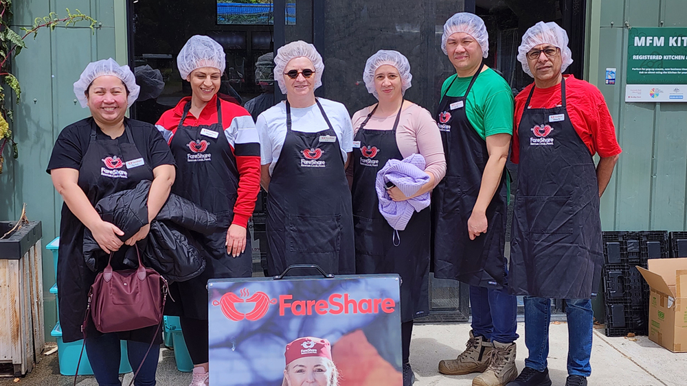 Photo of Vocus volunteers with hair nets on ready for work in the kitchen