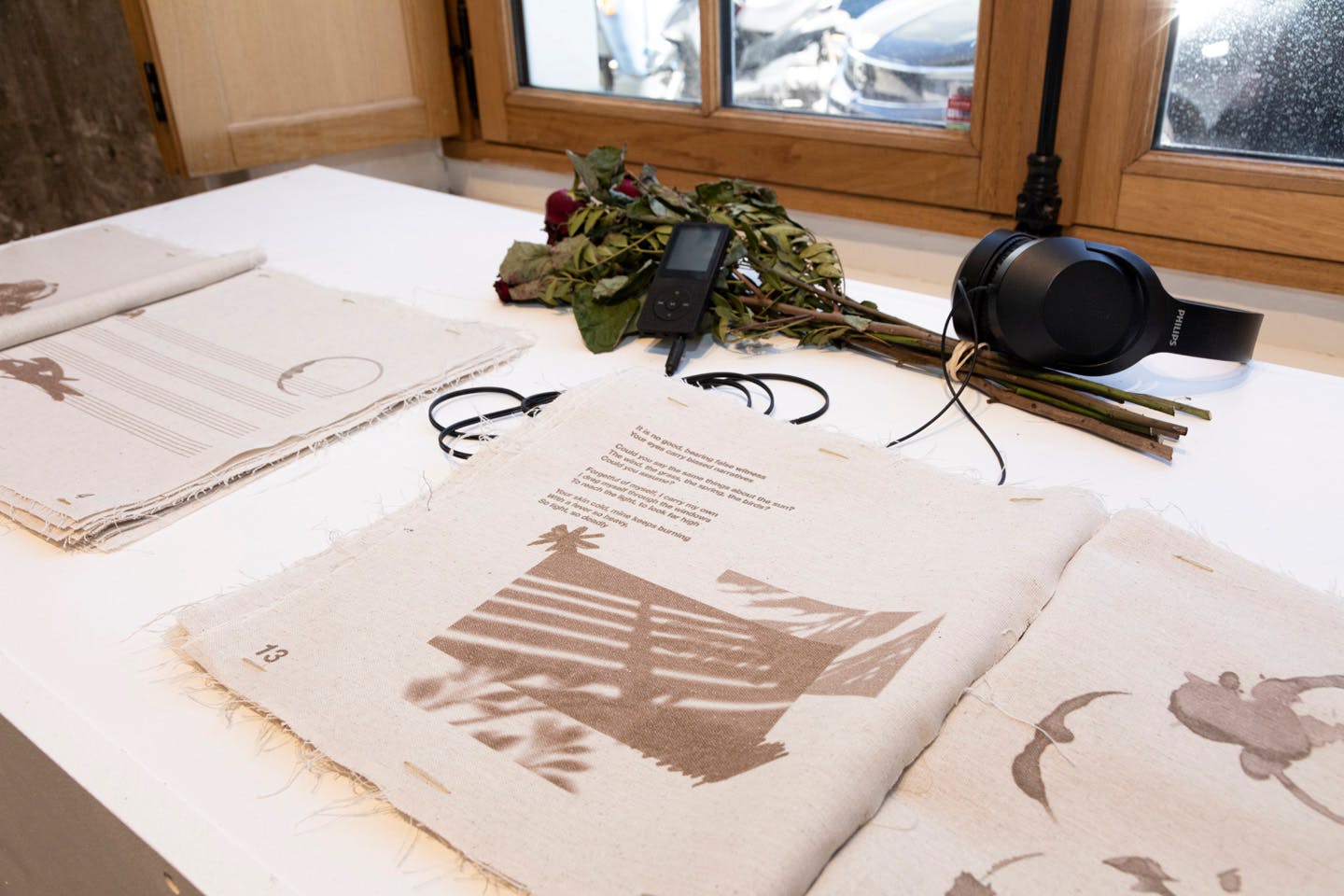 Fabric books with printed text and images displayed with headphones