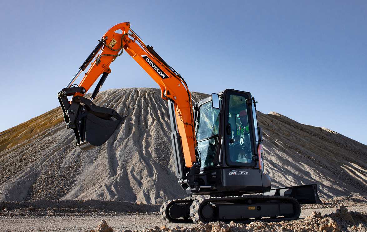 The DEVELON DX35Z-7 mini excavator works on a job site. 