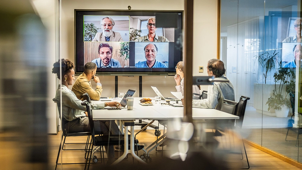 Stock image of Collaboration-Business-Workers-All-Watching-Screen-Meeting