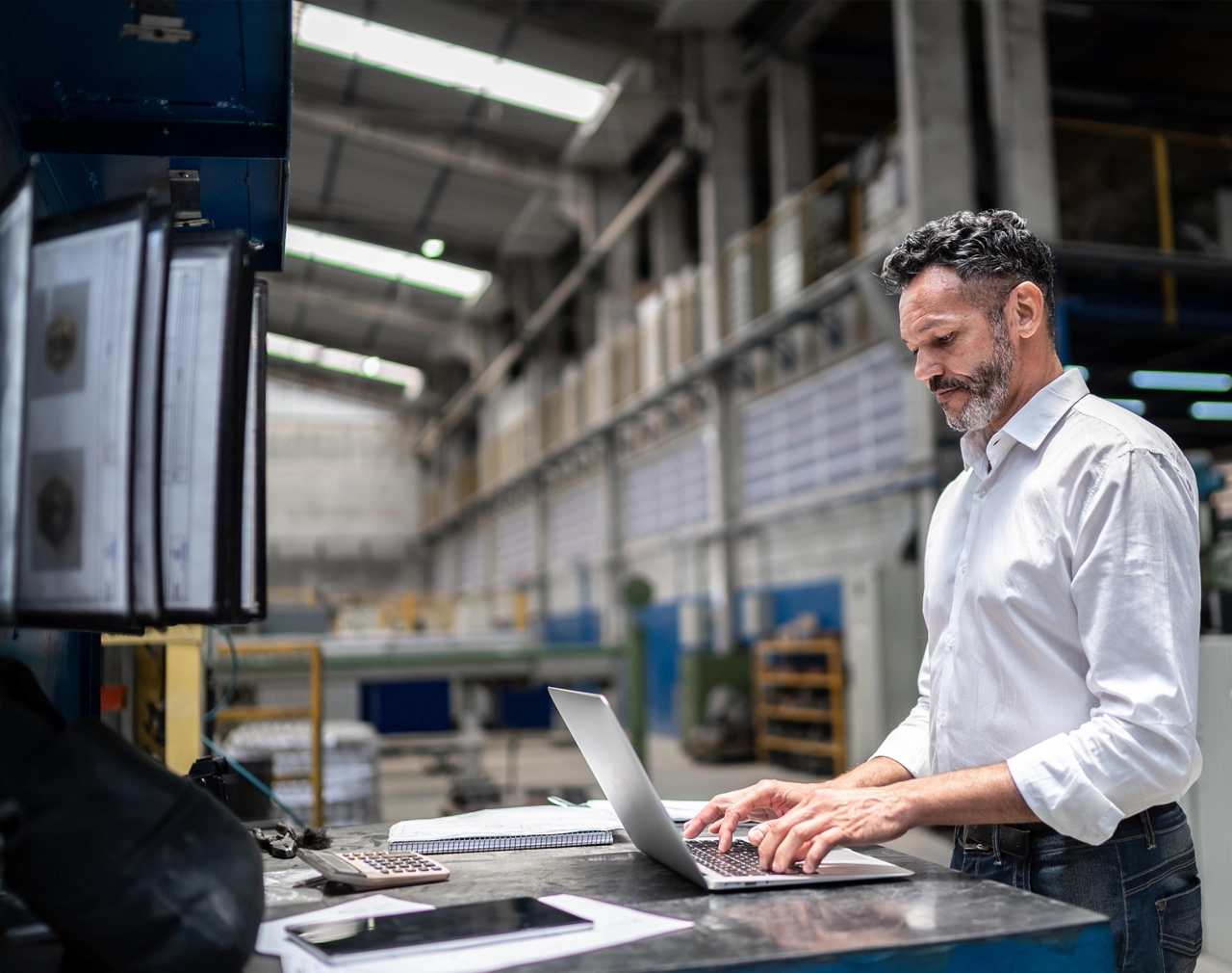 Stock image of a warehouse worker on a laptop