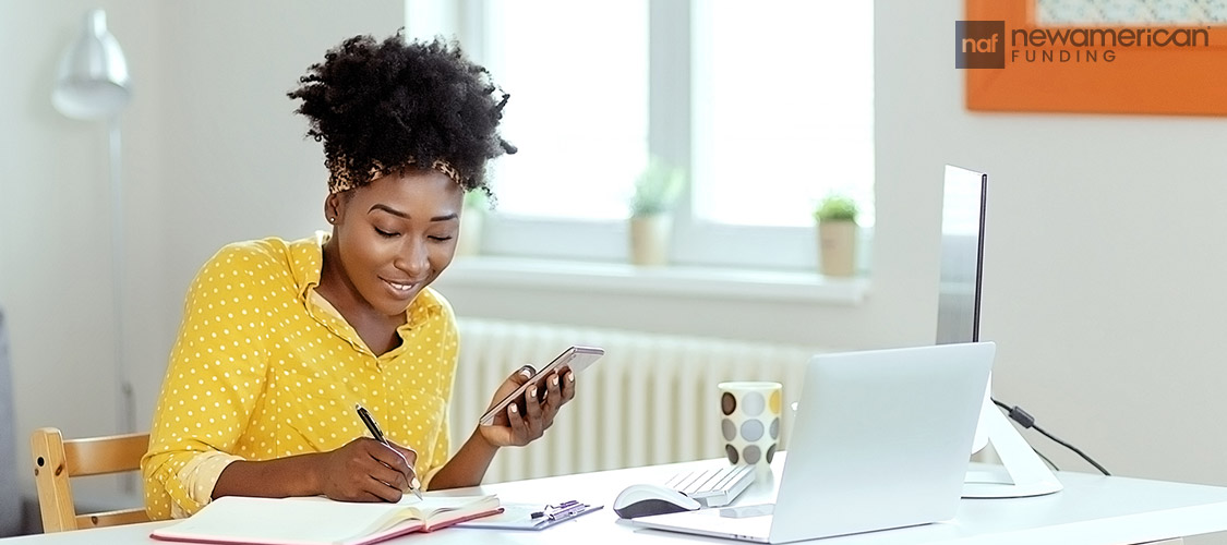 A woman smiling while budgeting