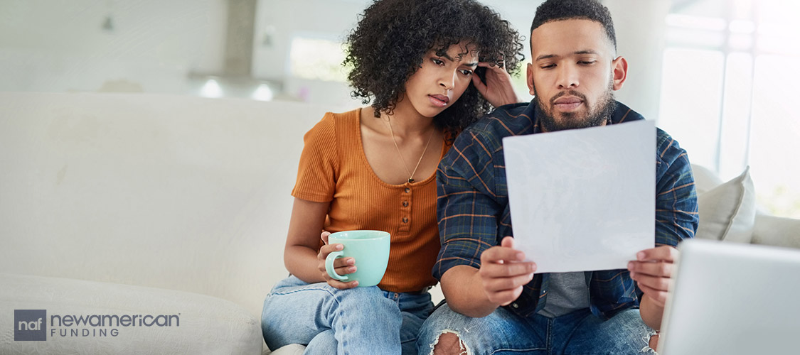 concerned couple going over paperwork