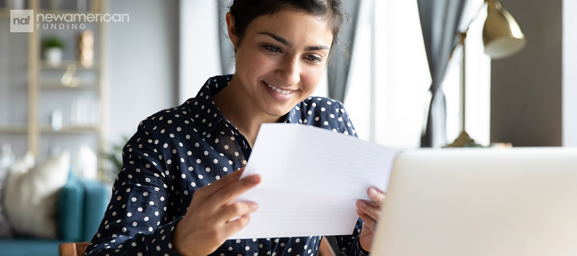 young woman smiling at paperwork