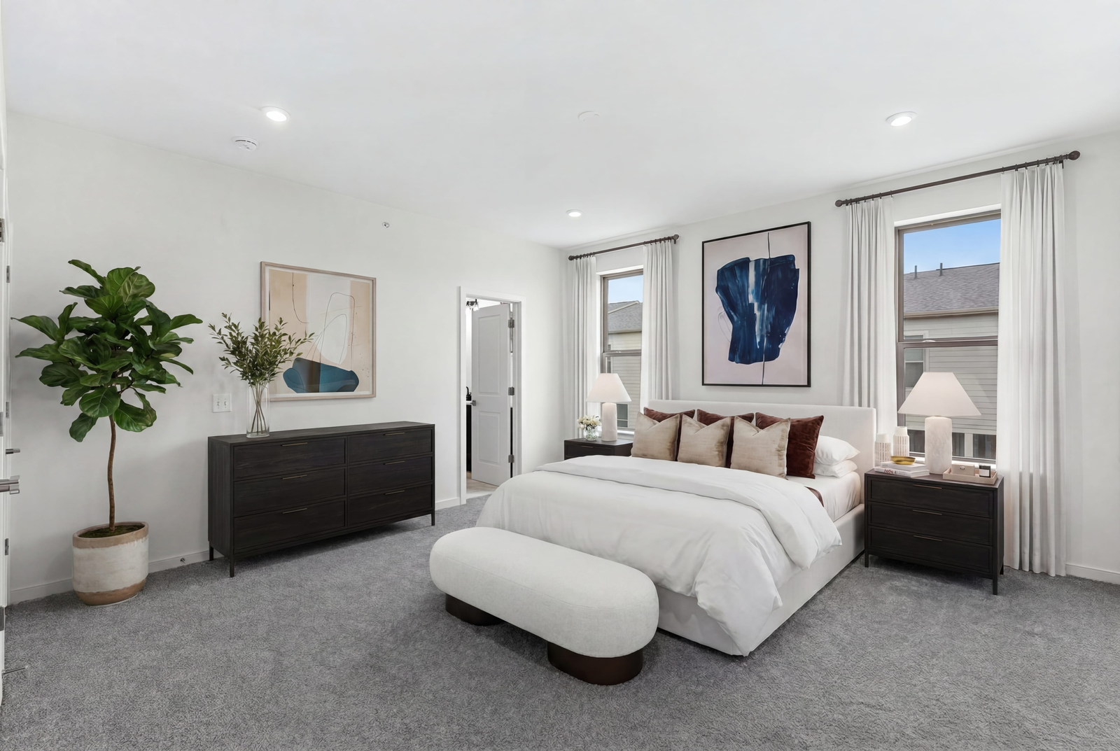 large bed with dresser and paintings