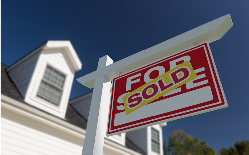 A close-up of a sold sign