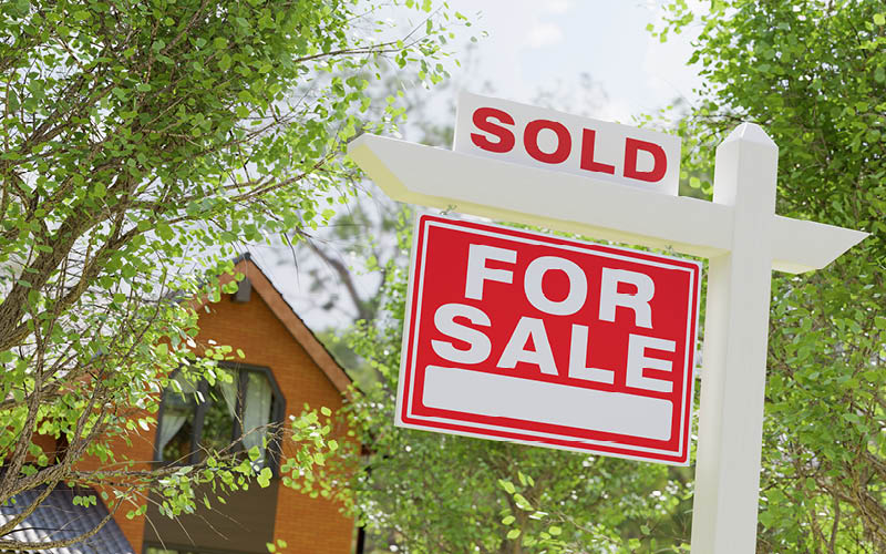 A sold sign on a post