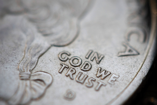 Coin that is zoomed in on "In God We Trust"