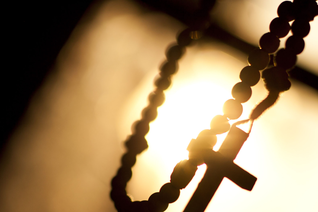 A rosary in front of the sun