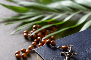 A rosary on top of a book