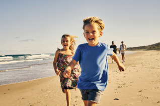 Kids running at the beach