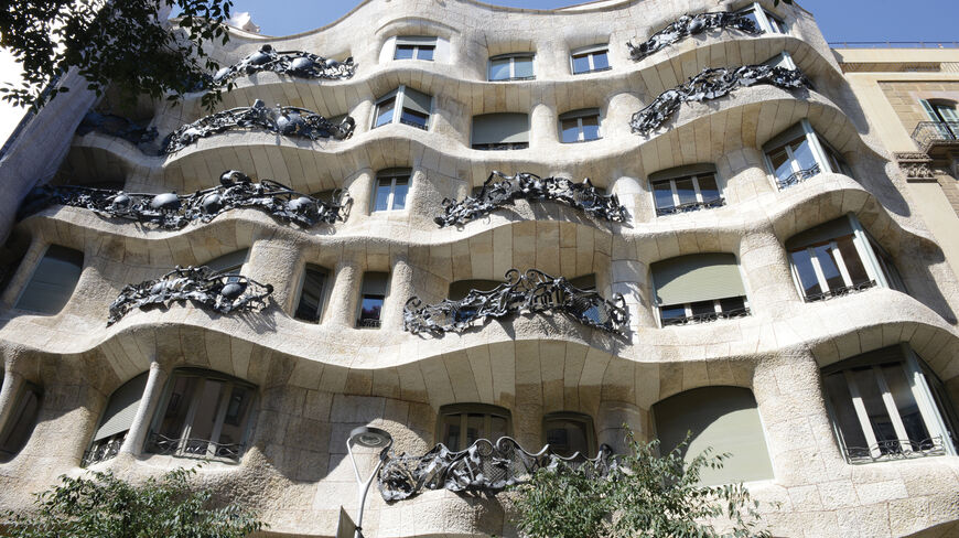 The wavy stone facade and intricate iron balconies of Casa Milà showcase the bold architecture found in Barcelona, Spain.
