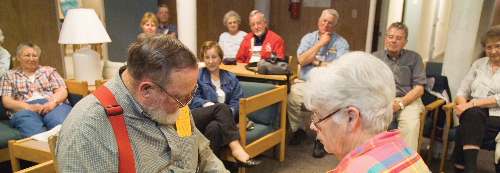 A group of older adults sit in chairs in a circle during a presentation at the Great Smokies in Tennessee.