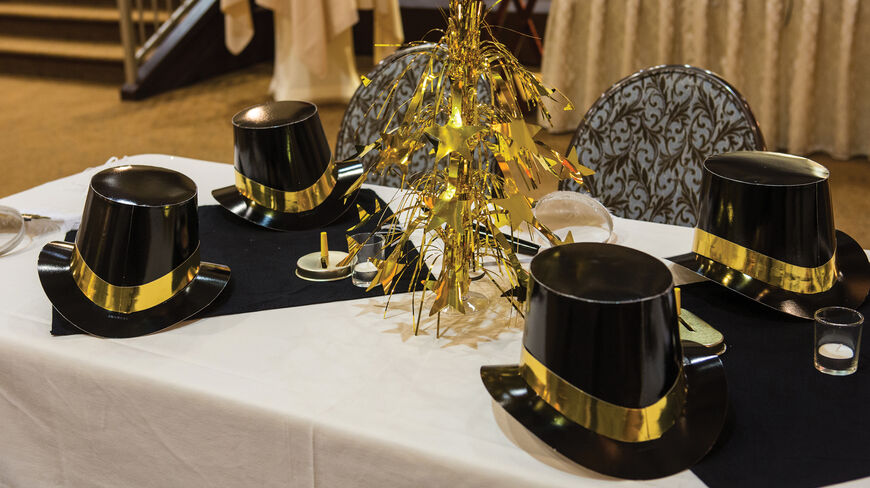 Black top hats and a gold star centerpiece decorate a table for New Year's Eve festivities at the Jekyll Island Club in Georgia.