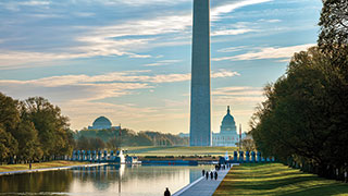The Washington Monument towers over the Reflecting Pool on the National Mall in Washington, D.C., with the U.S. Capitol in the background.
