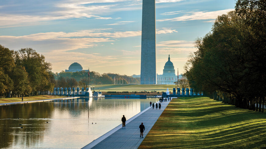 A scenic view of the Washington Monument and U.S. Capitol Building across the Lincoln Memorial Reflecting Pool in Washington, D.C.