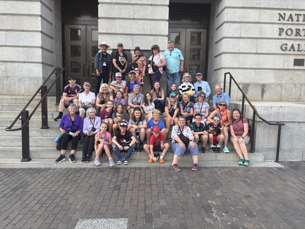 A group of grandparents and grandchildren pose for a photo on the steps of the National Portrait Gallery in Washington, D.C.
